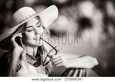 Beautiful Girl Talking On A Mobile Phone On The Beach