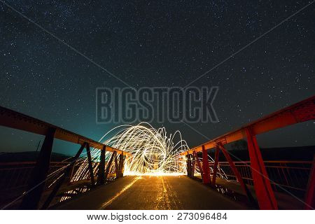 Light Painting Art Concept. Long Exposure Shot Of Spinning Steel Wool In Abstract Circle Making Fire