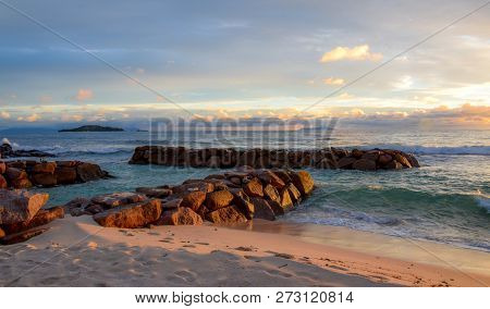 Stone Breakwater Shined With Warm Sunset Light.