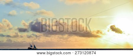 Two-sails Ship With Sunset Sky On The Background