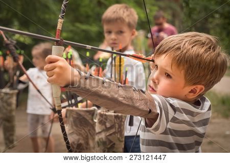 Boys With A Bow And Arrow. Children And Sports.