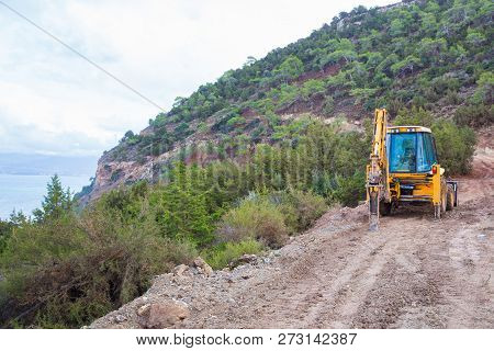 Yellow Excavator On The Hill, Dirty Way. Urban View. Travel Photo 2018, December.
