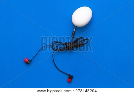 Chicken Egg With Headphones Body Is Walking On The Blue Background.