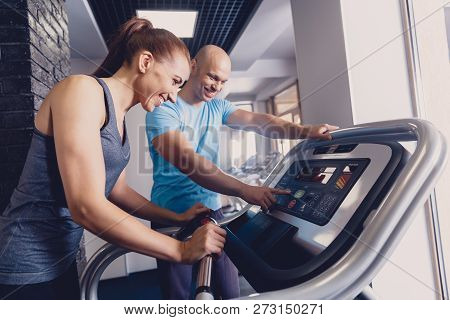 Personal Training With A Trainer On A Treadmill. The Trainer Controls The Correctness Of The Exercis