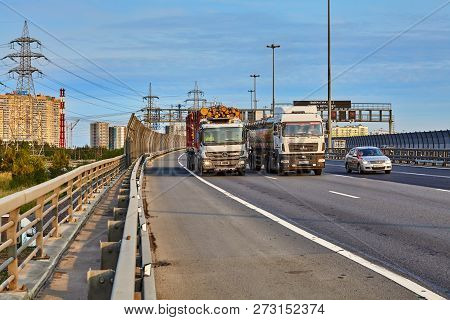 Saint Petersburg, Russia - August 28, 2018: Trucks Drive Along The Ring Road With Road Fence Barrier