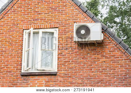 Brick Wall Of Home With Window And Air Conditioner