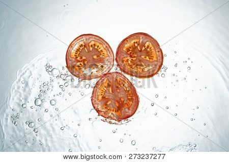 Freeze Motion Kiwi Water Splash On White Backgroundtomatoes Water Splash On White Background