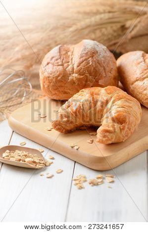 Homemade Croissant And Bread On Old Wood