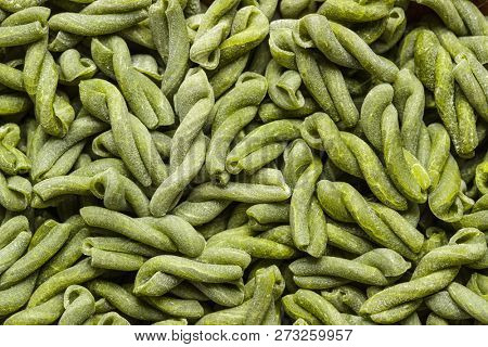 Uncooked spinach gemelli pasta. Top view.