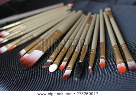 Set Of Cosmetology Brushes On A Black Background