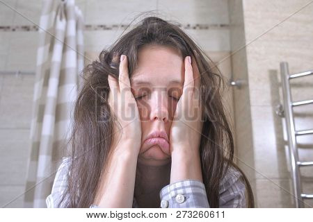 Woken Tired Woman In The Bathroom With Hangover And Headache.