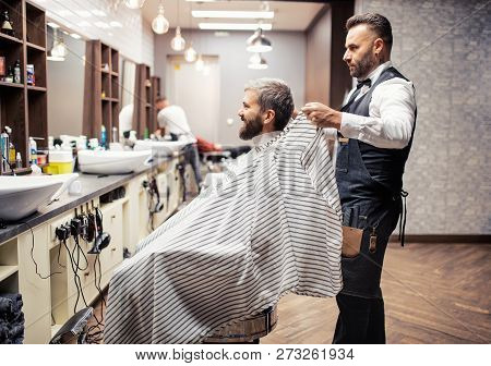 Hipster Man Client Visiting Haidresser And Hairstylist In Barber Shop.