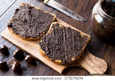 Black Olive Tapenade On Bread With Knife And Jar