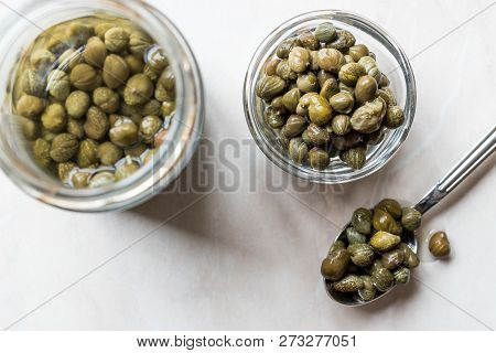 Jar Of Capers In Glass Bowl.