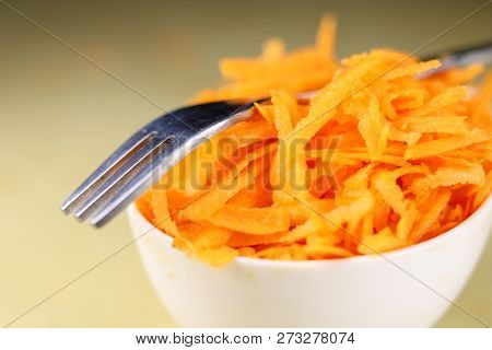 Fresh Carrot Grated On A Metal Kitchen Grate. Vegetables Prepared For Salad With A Meal On The Kitch