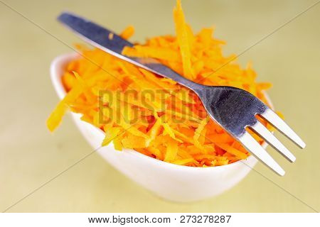 Fresh Carrot Grated On A Metal Kitchen Grate. Vegetables Prepared For Salad With A Meal On The Kitch