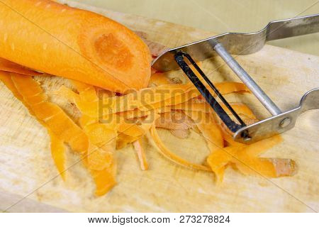 Fresh Carrot Grated On A Metal Kitchen Grate. Vegetables Prepared For Salad With A Meal On The Kitch