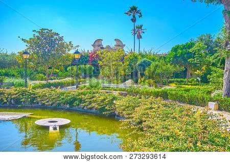 Naxxar, Malta - June 14, 2018: The Beautiful Lush Garden Of Palazzo Parisio With Small Round Pond An