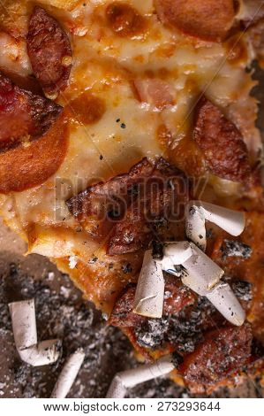 Cigarette Butts In The Remains Of Pizza. The Consequences Of A Drunken Party.