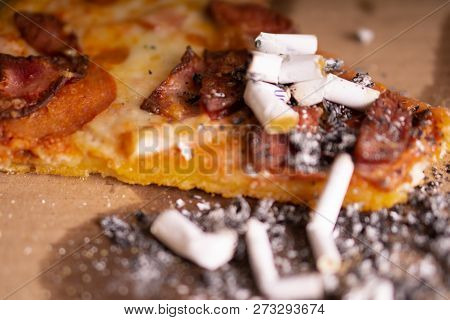 Cigarette Butts In The Remains Of Pizza. The Consequences Of A Drunken Party.