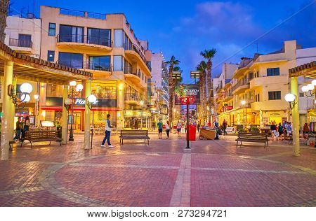 Bugibba, Malta - June 14, 2018: The Evening Activity At The Bugibba Square, With Tourists Walking Al