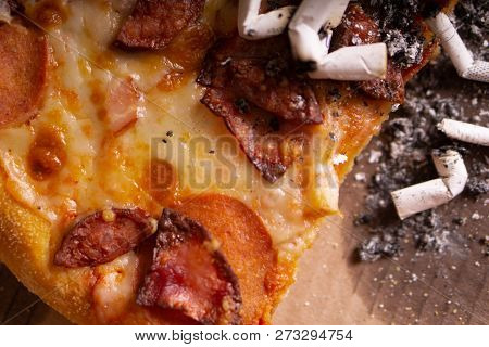 Cigarette Butts In The Remains Of Pizza. The Consequences Of A Drunken Party.