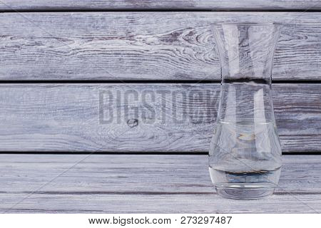 Glase Vase With Water On Wooden Background. Decorative Clear Glass Vase And Copy Space. Beauty And F