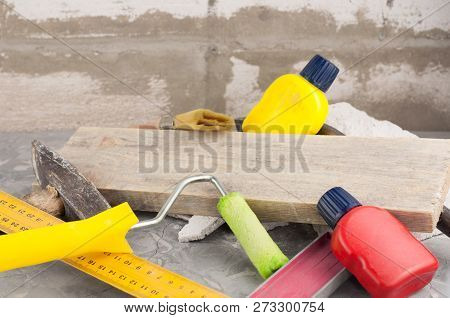 Stone And Old Hammer With Wooden Handle And Nail And Metal Nail Puller And Yellow Ruler And Brown Pl