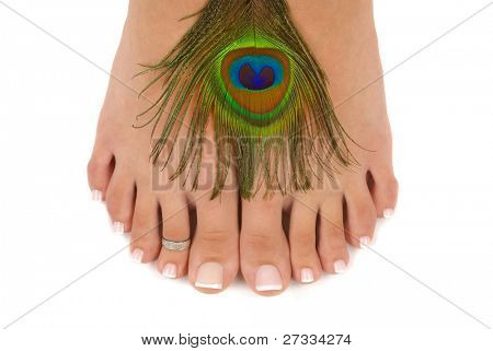 Pedicured feet and peacock feathers