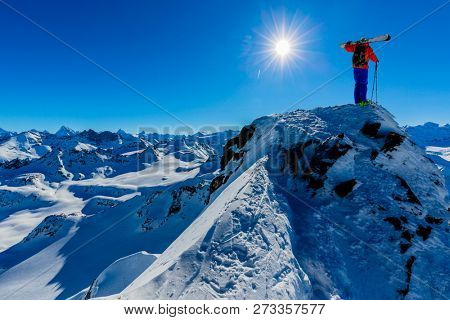 Ski touring with amazing view of swiss famous mountains in beautiful winter powder snow of Alps. 