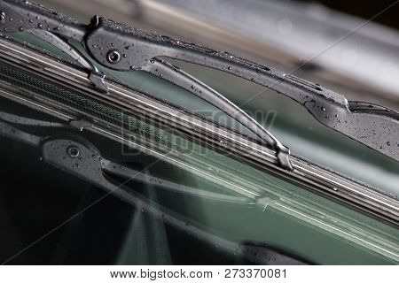 Car Windshield Wiper Closeup. New Car Wiper With Raindrops.