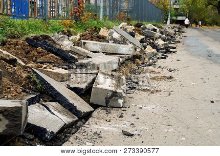 Broken Freshly Dug Up Old Curbstones With Pieces Of An Asphalt And Earth Lying On The Road In Moscow