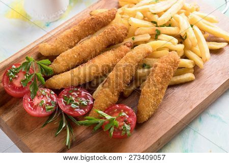 Deep fried chicken frites with potato chips or french fries