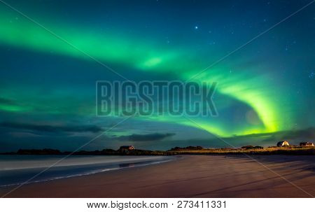 Northern lights, beautiful landscape of a green light in the night starry sky, amazing natural beauty of Lofoten archipelago, Gimsoya, Norway