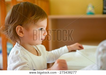 Toddler Aged Child Watching A Tablet In Her Room