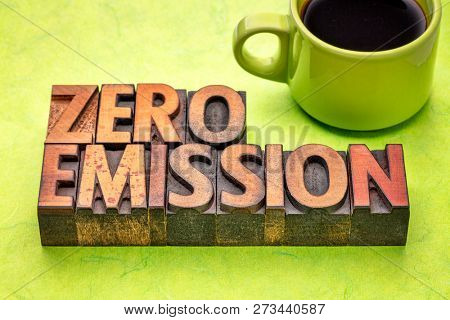zero emission - word abstract in vintage letterpress wood type with a cup of coffee