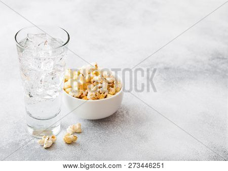 Glass Of Lemonade Soda Drink With Ice Cubes And Whitel Bowl Of Popcorn Snack On Stone Kitchen Backgr