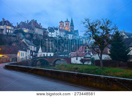 Scenic view from the river embankment Armancon at dusk,  Semur-en-Auxois, Burgundy, France.