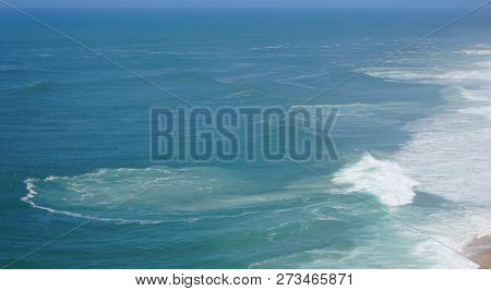 Rough Waves Touching Coast At Nazare In Portugal