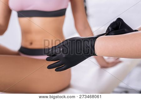 Slim Woman With Athletic Body Sitting On Bed Visiting Her Waxer