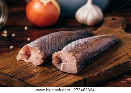 Hake Carcasses On Cutting Board With Pepercorn, Garlic And Salt