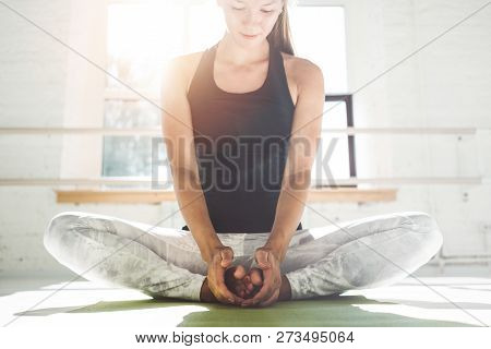 Young Strong Woman Doing Core Stretching On Fitness Mat In The White Interrior Gym. Fit Female Doing
