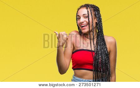 Young braided hair african american with pigmentation blemish birth mark over isolated background doing happy thumbs up gesture with hand. Approving expression looking at the camera