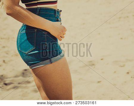 Woman Showing Her Sexy Curves. Hips And Legs Body Part In Short Denim Shorts.