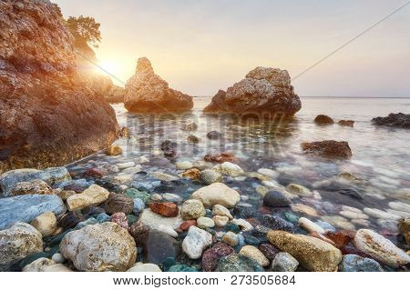 Dramatic Beautiful Sunset On A Rocky Coast. Long Exposure Photography