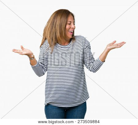 Beautiful middle age woman wearing stripes sweater over isolated background Smiling showing both hands open palms, presenting and advertising comparison and balance