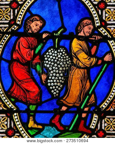 Men Carrying Grapes, Symbolizing The Blood Of Christ