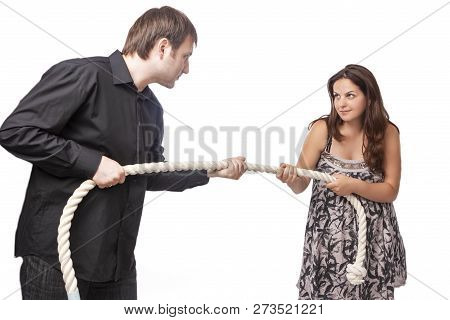Young Caucasian Couple Towing A Rope To Each Other. Concept Of Separation And Divorce.horizontal Ima