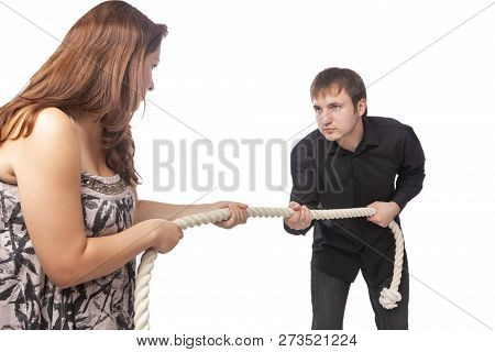 Portrait Of Young Caucasian Couple Towing A Rope To Each Other. Concept Of Separation And Divorce.ho