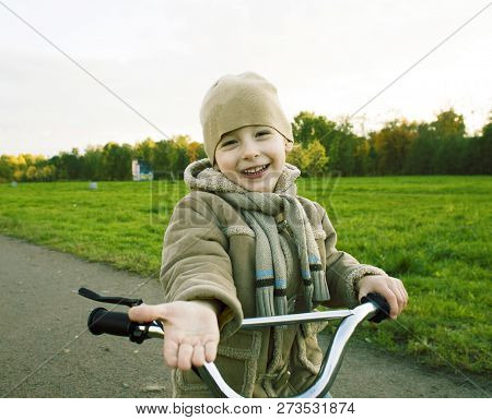 Little Cute Real Boy On Bicycle Emotional Smiling Close Up Outsi